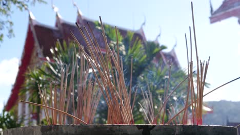 Thai-incense-sticks-on-the-background-of-a-temple