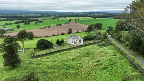 aerial flt to romantic church in fertile green farmlands of waterford ireland on a september morning