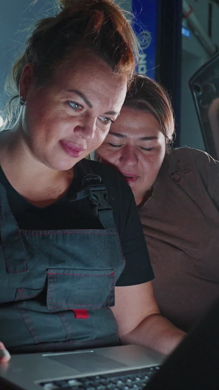 Women Mechanics Working Together on a Laptop