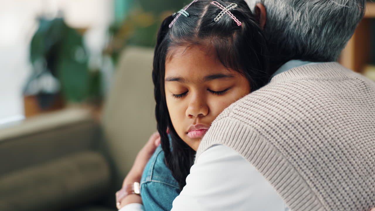 A granddaughter hugging her grandfather