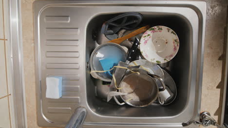 The-Sink-Is-Filled-With-Dirty-Dishes-Many-Dishes-Need-To-Be-Washed-Top-View