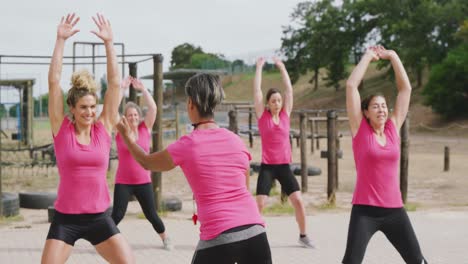 female friends enjoying exercising at boot camp together