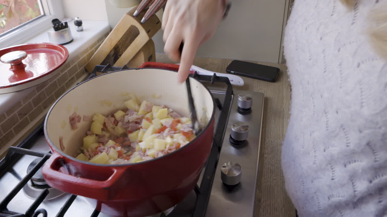A woman cooking food in the kitchen