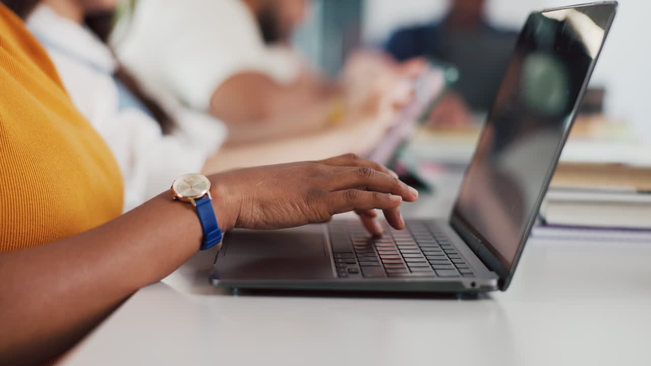 Close Up of Hands Typing on Laptop Keyboard