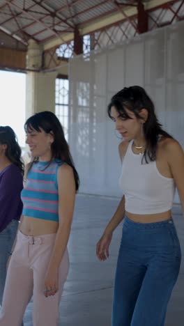 two young women walk through a spacious, modern indoor setting