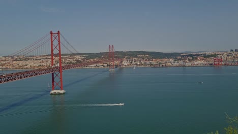 panoramic view of the 25th april bridge on a bright and sunny day in lisbon, portugal