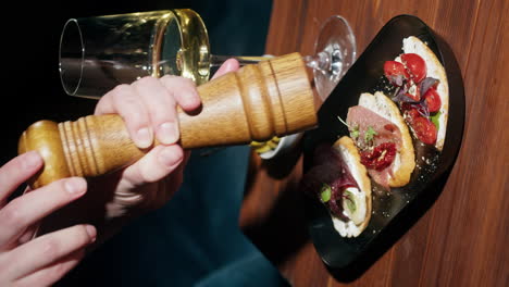 Close-up of Bruschetta and Appetizers with Wine and Pepper Grinder