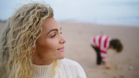 Portrait-beautiful-mother-enjoy-seaside-weekend.-Family-picnic-on-autumn-beach