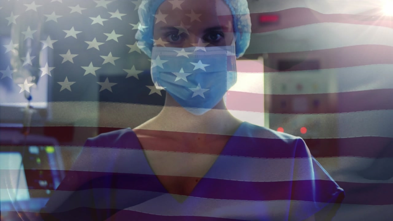 A female surgeon is standing with her arms crossed in an operating room at a hospital