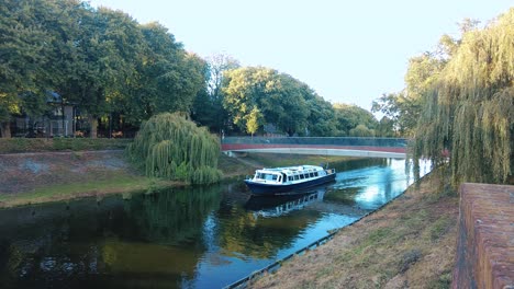 Boat-sails-under-bridge-through-the-canal-of-the-meuse-in-the-center-den-bosch