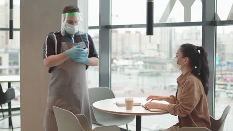 waiter taking contactless payment with card