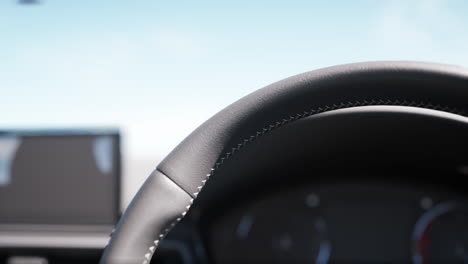 close up of a black leather steering wheel in a car