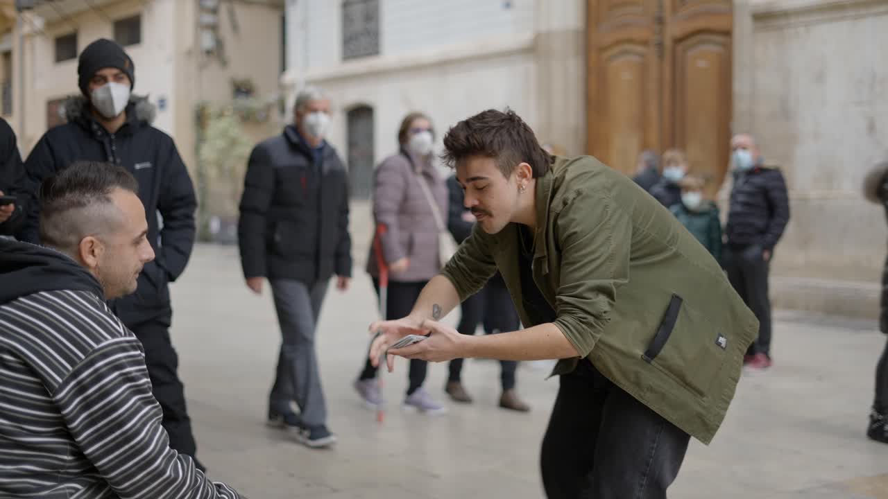 Street Magician Performing Card Tricks