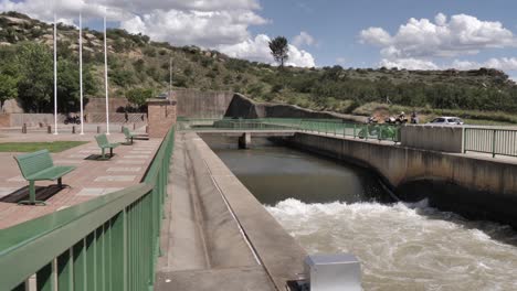 high flow water from underground pipeline outfall flows over weir