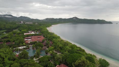 A-4K-drone-shot-of-Playa-Conchal,-or-“Shell-Beach”,-and-Puerto-Viejo,-next-to-the-Mirador-Conchal-Peninsula,-along-the-north-western-coast-of-Costa-Rica