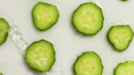 rotation cucumber slices with gel on white background