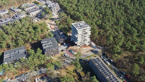 Aerial-overview-of-multiple-apartment-buildings-with-photovoltaic-solar-panels-on-rooftop