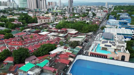 drone volando hacia adelante sobre el suburbio hacia la ciudad de quezon en filipinas