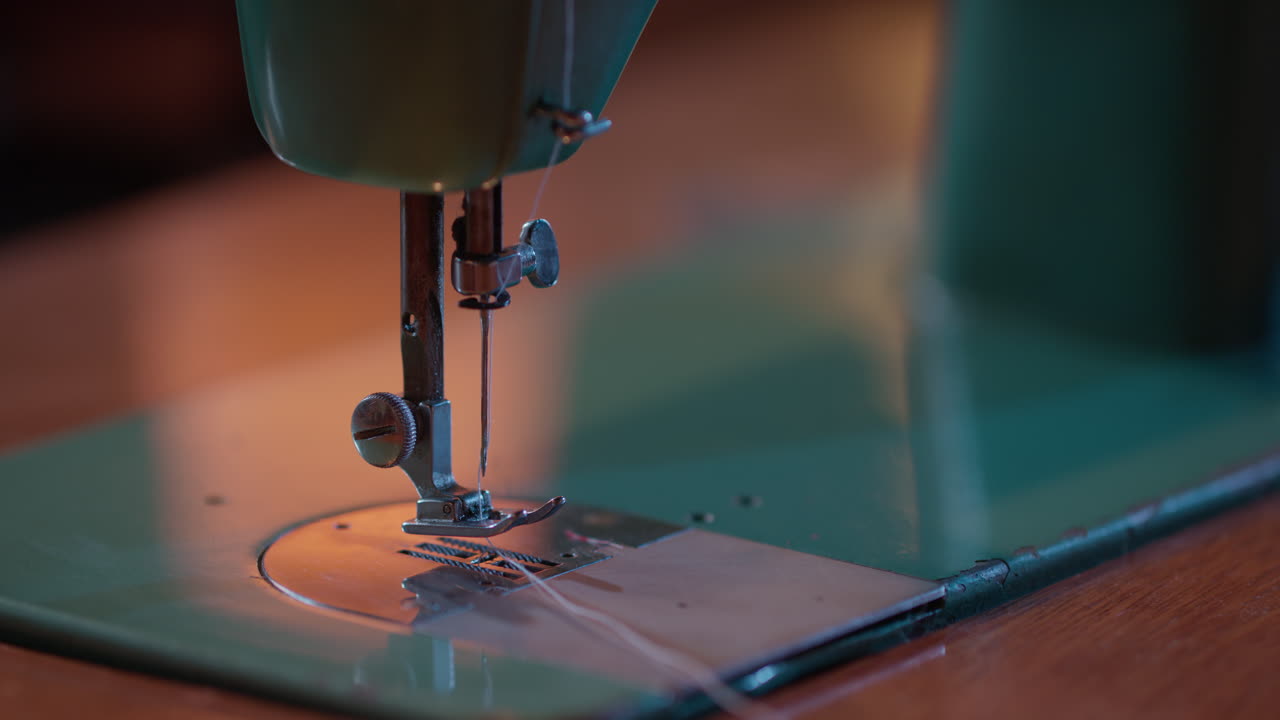 Close-up of Hands Sewing Floral Fabric on a Vintage Sewing Machine