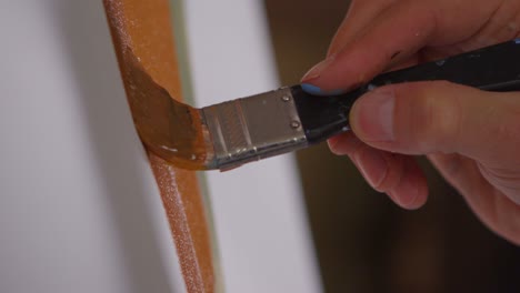 closeup of an artist daubing paint on a canvas