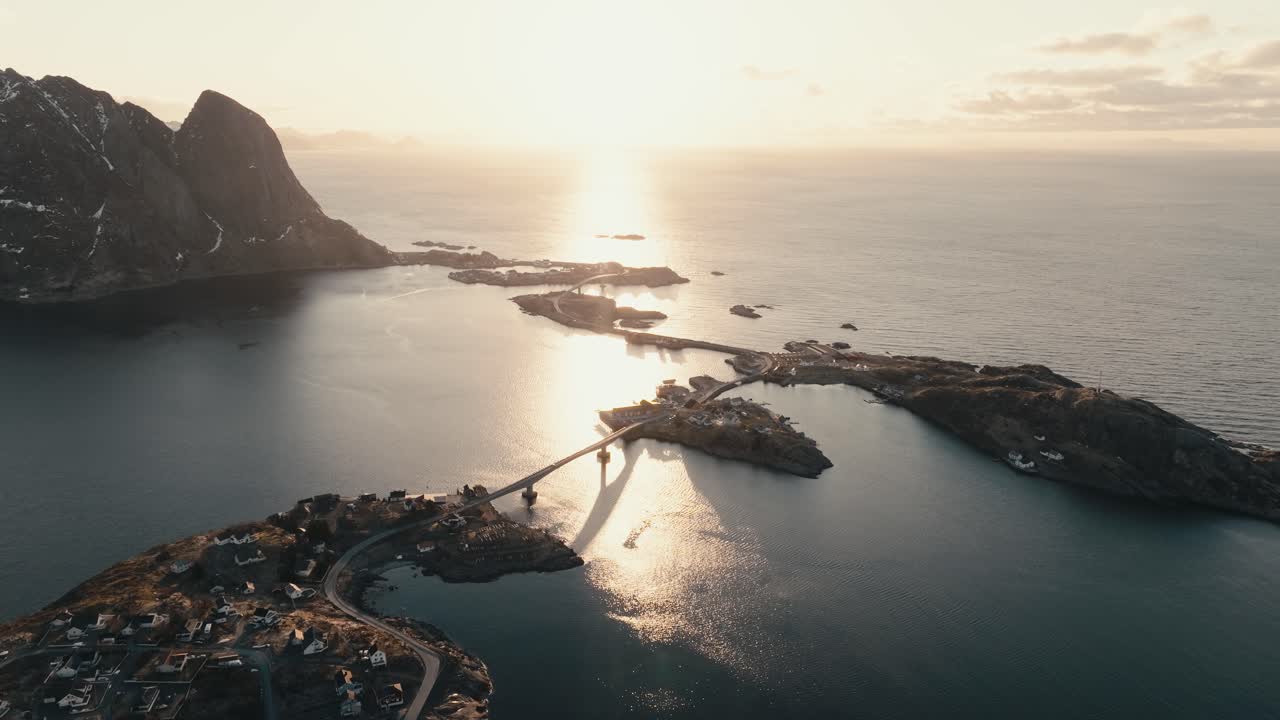 Bright Sun Shining Over The Calm Sea And Fishing Village Of Reine In Nordland, Norway. - aerial shot