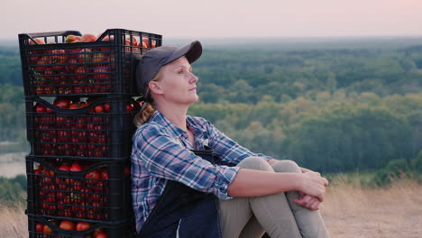 Woman-Farmer-Resting-After-Work-Sitting-Near-Boxes-With-Tomatoes