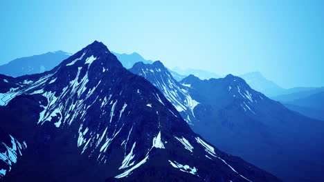 snow capped mountains under clear blue sky in a remote landscape