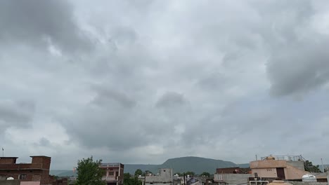 Timelapse-of-clouds-moving-fast-over-an-Indian-town,-cloud-before-the-rain,-Rainy-clouds-over-town