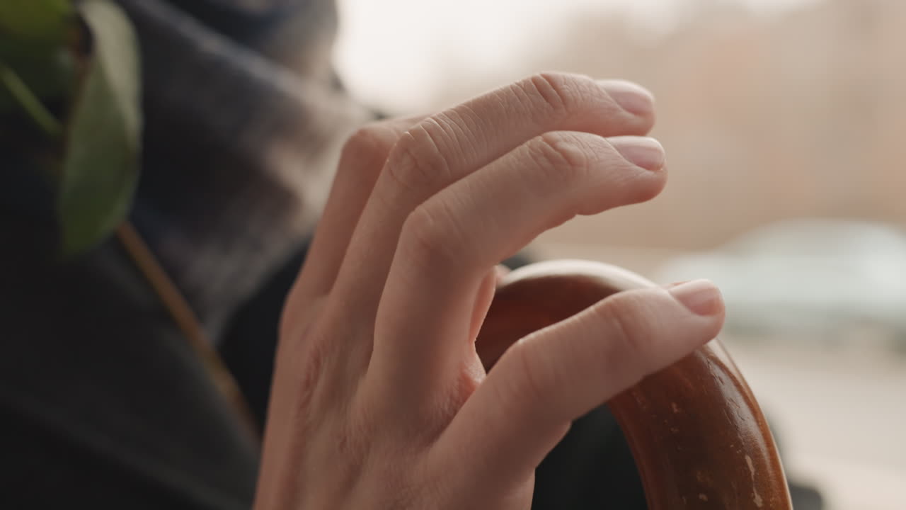 Soft fingertips glide smoothly over wood. Delicate touch as fingers softly explore polished timber surface. Caressing fingers move gently across finely finished wooden material in harmony