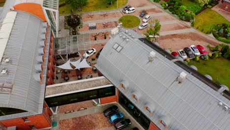 Cars-Parked-In-Rows-Outside-Hotel-And-Spa-Buildings-In-Wadowice,-Poland