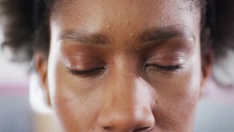 Close-up-video-portrait-of-blinking-eyes-of-happy-african-american-woman-smiling-to-camera