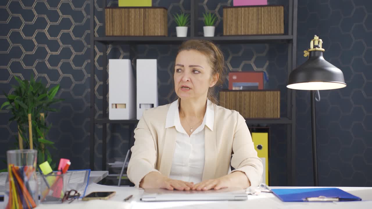 la mujer de negocios que ve los malos acontecimientos en la computadora portátil se enoja.