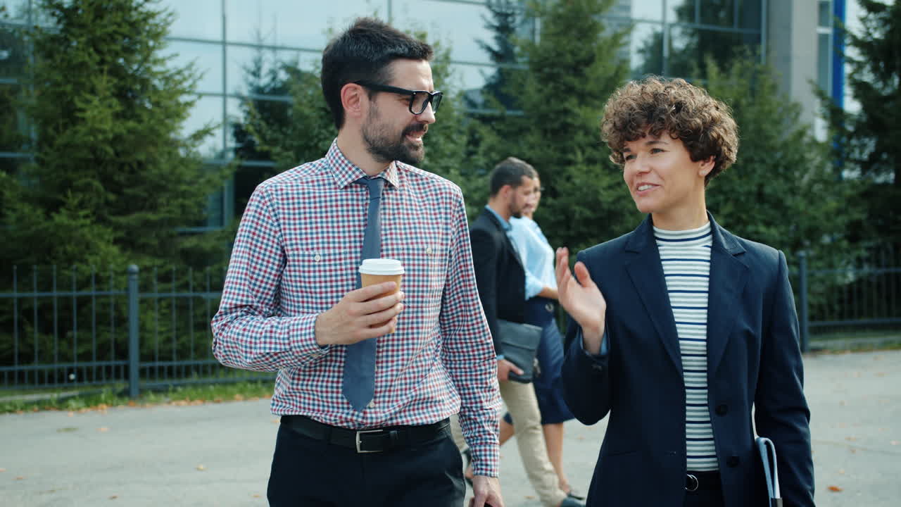 Business Colleagues Walking and Talking Outdoors