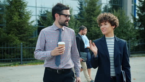 business colleagues walking and talking outdoors