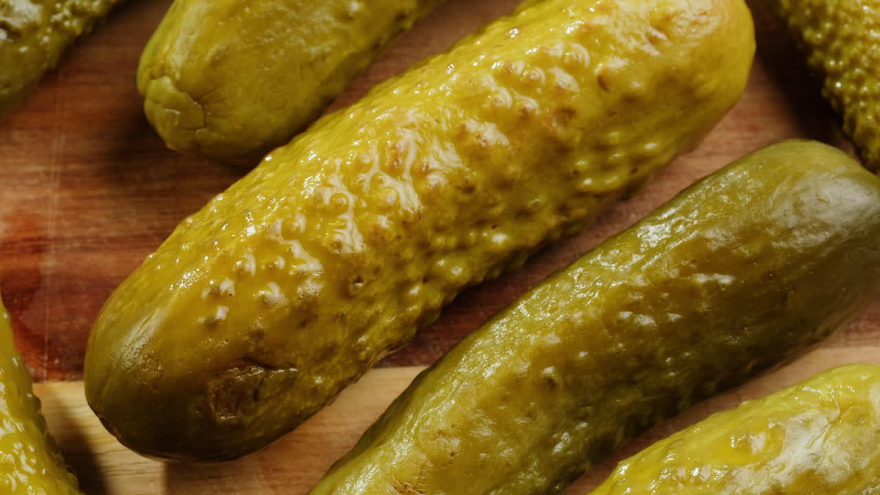 Close-up of Pickled Cucumbers on a Wooden Board