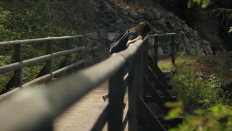 young woman in a wooden bridge in the alps switzerland