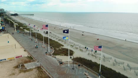 aerial push-in shot of flags on boardwalk at myrtle beach