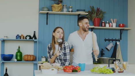 couple singing and having fun in the kitchen