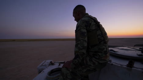 soldier on watch at sunset