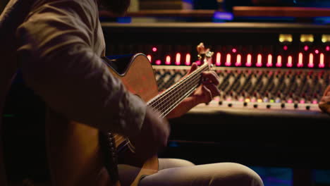 songwriter composing a song with sound engineer in professional studio