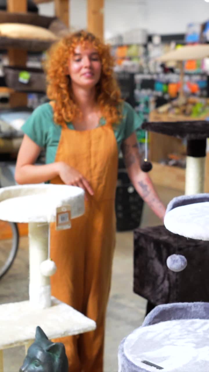 A woman shops for a cat tree in a pet store