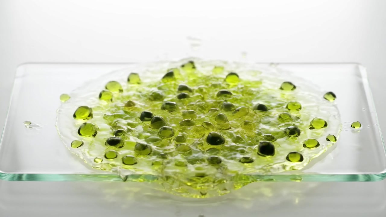 Green Liquid Droplets Splashing and Spreading on Glass Surface