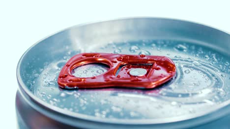 aluminum soda tin can lid cover of soft drink on ice goes around the circle.