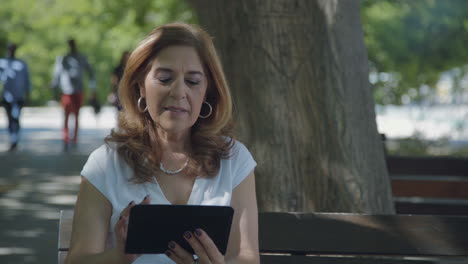 woman googling on tablet, nodding head, looking satisfied