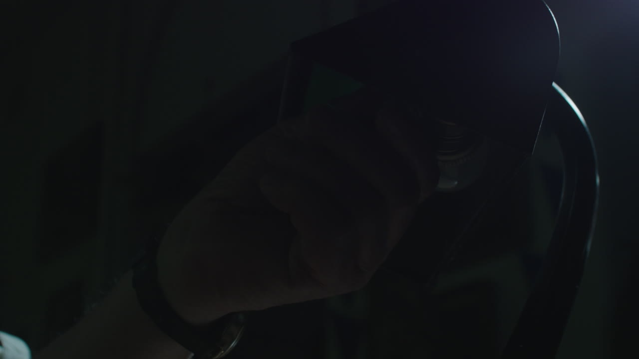 An old man's hand turn on the vintage lamp