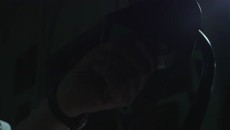 an old man's hand turn on the vintage lamp