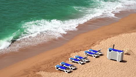 aerial view of some beach loungers with rough sea