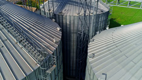 commercial grain or seed silos in sunny spring rural landscape