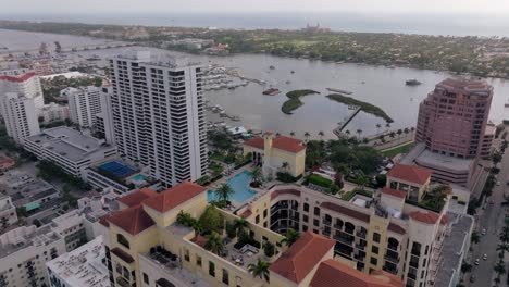 aerial view of a luxurious waterfront cityscape with marina and resort buildings