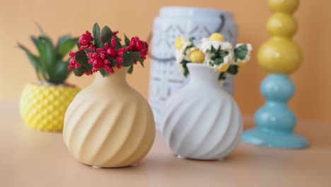 yellow and blue ceramic vases with flowers